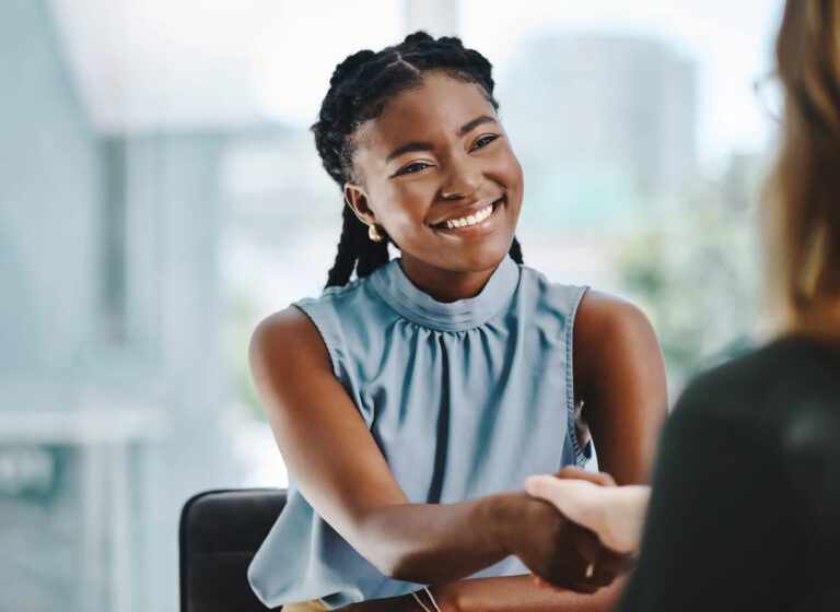 woman-smiling-talking-to-another-woman